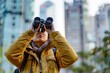 bird watcher with binoculars, metropolis in sight