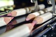 closeup of makeup pencils being sharpened by machine