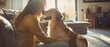 © arhendrix - Female pet sitter, Caucasian, joyfully playing with a dog in a sunlit modern living room,