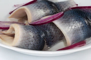 Wall Mural - Pickled herring fillets with onion slices, side view close-up