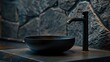 Stylish black marble vessel round sink and faucet on stone countertop. Interior design of modern bathroom.