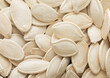 Raw white salted pumpkin seeds top view macro background.Healthy snack.