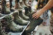 salesperson arranging combat boots on display