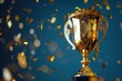 © Deivison - Golden trophy and falling confetti, sports, business and competition concept.
