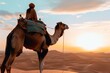 side profile of person atop camel with expansive desert horizon