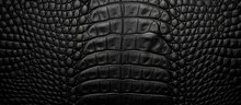 A Detailed Shot Of A Black Crocodile Skin Texture, Resembling The Tread Pattern Of An Automotive Tire. The Grey Scale And Intricate Grille Pattern Create A Sense Of Darkness And Sophistication