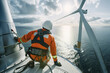 Technician inspecting a wind turbine at sea