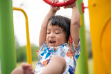 Fototapeta Desenie - Adorable preschool boy enjoying bar lifting in outdoor playground in city park