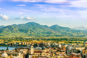 Wall Mural - panoramic summer travel view from a hill to  beautiful sea coast historical town with port, amazing ocean bay and gulf and beautiful mountains with scenic sunset on background