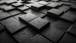 Monochrome image of black tiles with water droplets, reflecting light with selective focus