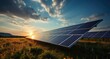 © Divine123victory - solar panels in the grass, blue sky with clouds and sun shining through the solar panel array landscape background, solar farm, alternative source of electricity.