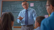 © Studio Nova - A seasoned educator discusses complex topics with students in front of a chalkboard filled with formulas.