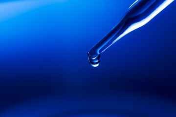 Wall Mural - water droplets macro science experiment,liquid drop from laboratory glass pipette