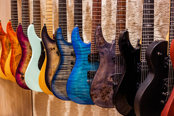 Group of colorful electric guitars in a music shop. Musical instruments for sale.