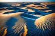 Sand dunes sculpted by the wind, their graceful curves contrasting against the deep blue of the sea in the background.