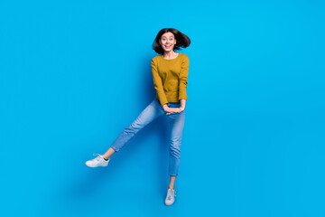 Wall Mural - full length photo of sweet adorable woman wear shirt dancing jumping high empty space isolated blue 
