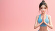 An animated fitness model in a blue sports bra demonstrates a prayer pose on a pink background