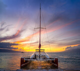 Fototapeta Miasto - sailboat with a maui sunset in the background