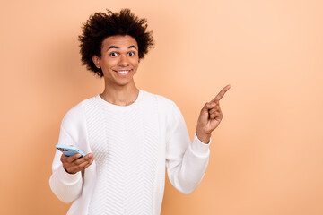 Poster - Photo of satisfied nice man wear trendy clothes recommend device shop modern technology empty space isolated on beige color background