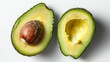 Two halves of a freshly cut avocado with a shiny pit, showing vibrant green flesh and textured skin on a white background.