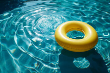 Yellow Pool Float, Ring Floating In A Refreshing Blue Swimming Pool