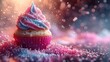  A pink and blue cupcake with frosting and sprinkles on a blurred background