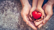 hands holding red heart, health insurance, Hands of woman and child with red heart on white background