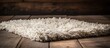 A close-up view of a fluffy white rug laid on a polished wooden floor