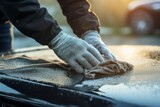 Fototapeta  - Man removing frost from car windshield on a chilly winter morning using hand scraper tool