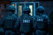 Swat team officers standing in front of a house