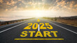 The beginning of the new year 2025. The word 2025 written on the asphalt road at sunrise. The concept of a new anniversary, new plans and goals.