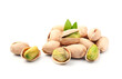 Pistachio nuts with leaves on white backgrounds .