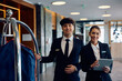 © Drazen - Young happy hotel staff looking at camera.