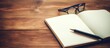© Ilgun - Person writing in notebook with pen and glasses on table