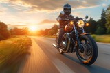 A motorcyclist enjoys the freedom of the open road at sunset, embodying the spirit of adventure and exploration