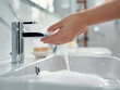 Person washing hands with soap and water in a modern sink for hygiene and health