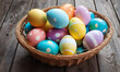 large wicker basket filled with variety of colorful Easter eggs on old wooden table. Concept of Pascha or Resurrection Sunday, Christian festival and cultural holiday