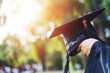 Student taking graduation cap on blur summer background, life style, free space for text.