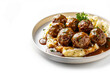 Traditional swedish meatballs with meat sauce and mashed potatoes on a plate. Kottbullar. White color background, side view. Space for text.