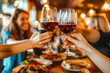 © MVProductions - Young smiling friends toasting wine at restaurant pub at happy hour with appetizers. Happy people having fun together.