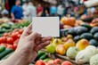 Hand Holding Blank Business Card at Farmers Market - Fresh Produce Marketing Concept