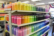 Art supply store with a rainbow of paints, quality brushes, and artists perusing materials for creative projects.