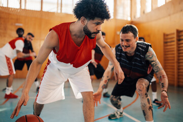 Wall Mural - Interracial basketball players playing basket on training.