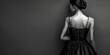 © edojob - Elegant woman in black dress looking over shoulder