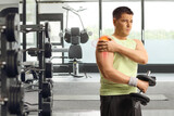 Fototapeta Panele - Man with shoulder injury and red inflamed area lifting weights