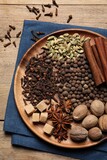 Fototapeta Mapy - Different spices and nuts on wooden table, top view