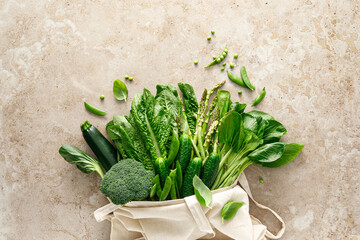 Poster - Green vegetable background. Various green vegetables in a shopping bag. Veggies. Shopping food supermarket and clean eating, healthy vegetarian, vegan food concept, delivery food, copy space, top view