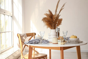 Poster - Autumn table setting with pampas grass and pumpkins in light kitchen