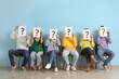 © Pixel-Shot - Applicants holding paper sheets with question marks near blue wall