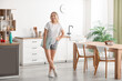 © Pixel-Shot - Beautiful sporty woman with scales in kitchen at home. Weight loss concept
